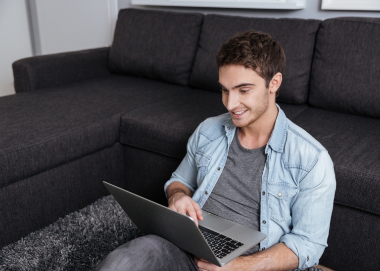 Guy with a laptop at home. Photo: Mostphotos