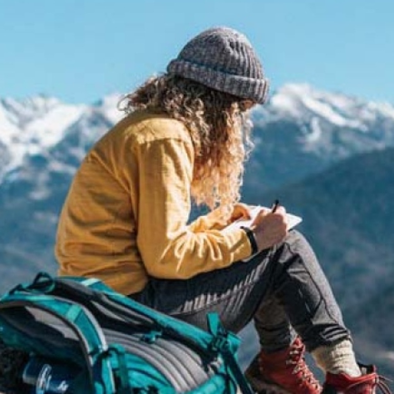 Female student sitting in the mountains. Photo: Tyler Nix