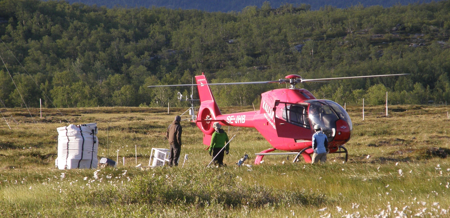 Helicopter on field with scientist around it. Photo: Patrick Crill