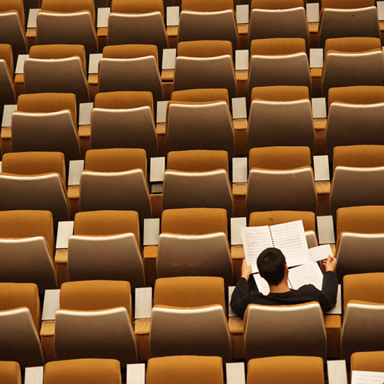 Person reading in lecture hall