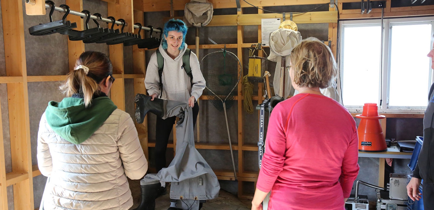 The students get waders and other equipment in one of the field station’s boat houses.