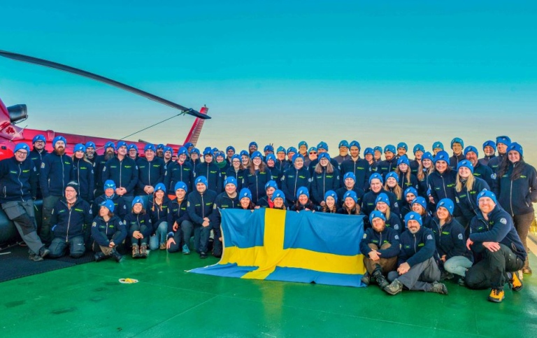 Researchers and crew on Oden with the Swedish flag. Photo: Paul Zieger/ACES/Stockholm University