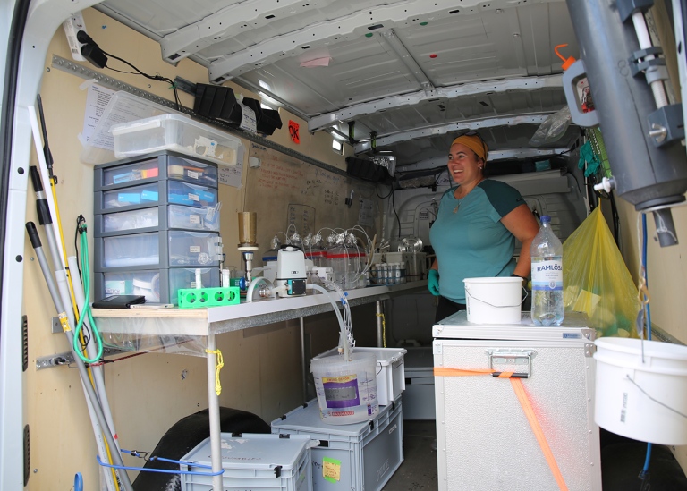 Small laboratories are set up in vans. Elisa Merz demonstrates one of the labs.