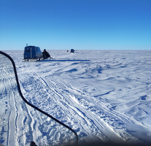 Snowmobiles pulling ARCs (mobile housing for researchers) after field work.