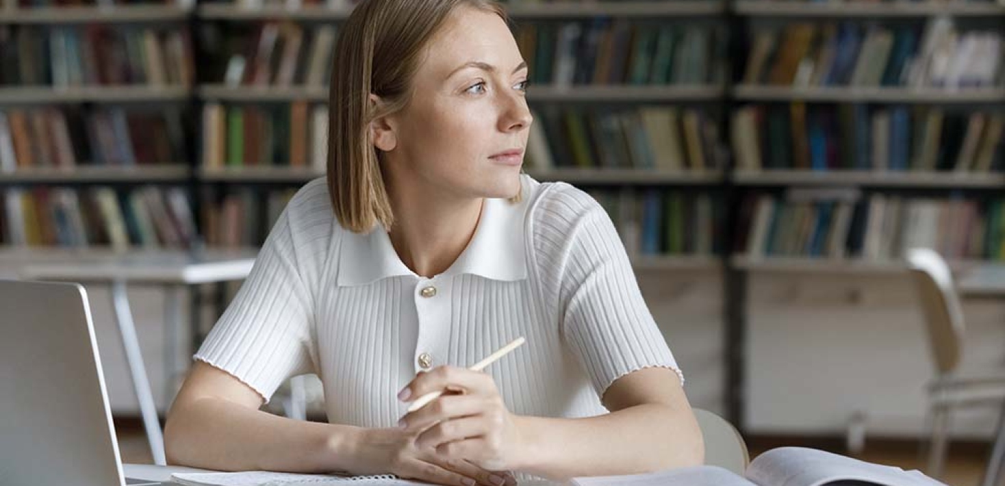 Library, thoughtful student girl working on essay