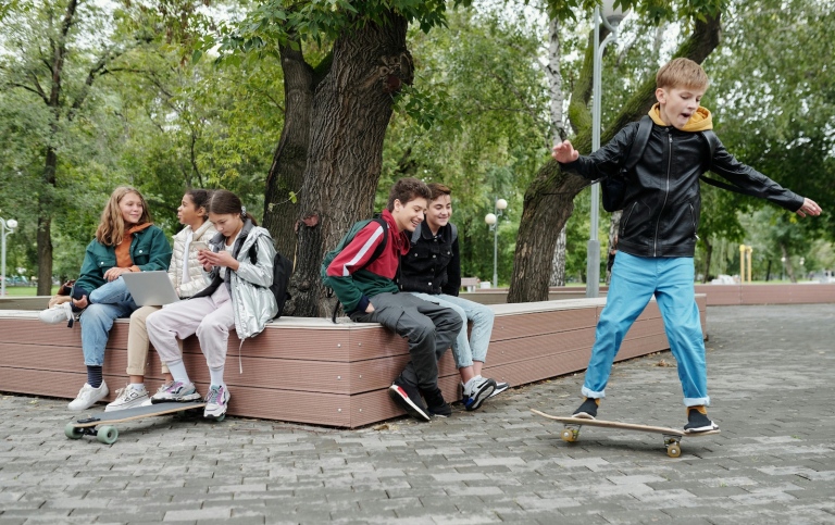 Children in a park with skateboards.