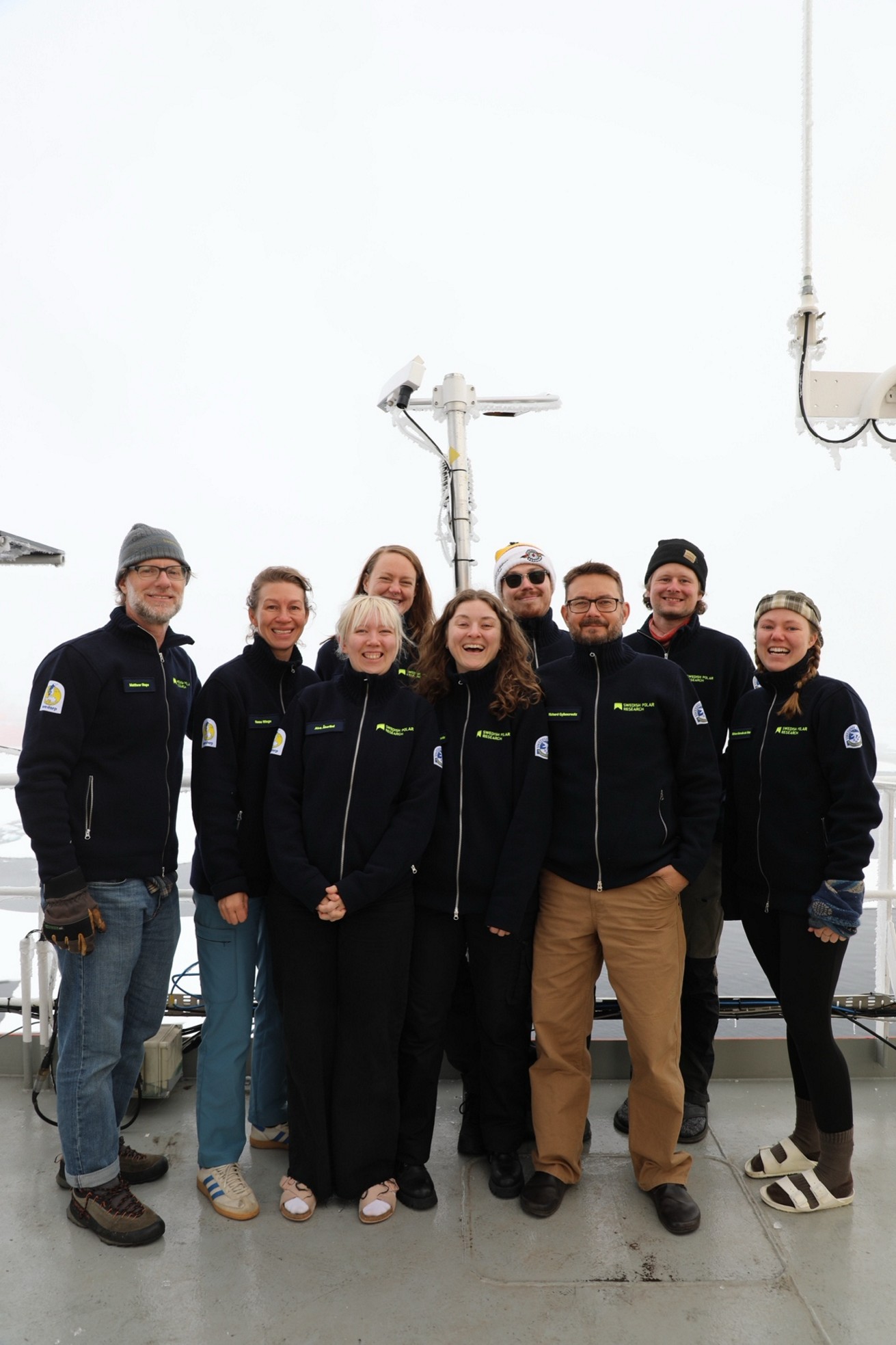 Caption: Group photo of all participants from SU on the 7th deck at the North Pole (From the left: Matthew Shupe (MISU), Hanna Winge (MISU), Alva Åkerlind (IGV), Linnea Huusko (MISU), Irene Bellagente (ACES), Albin Eriksson (ACES), Richard Gyllencreutz (IGV), Rune Bech Pedersen (IGV), Miriam De Vries (Physical Geography). Matthew O'Regan (IGV) is missing from the photo).