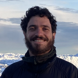 A bearded man smiling at the camera.
