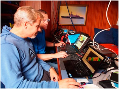 Two male scientists in front of the computers.