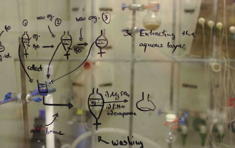 Organic chemistry doodles on the glas front of a fume hood.