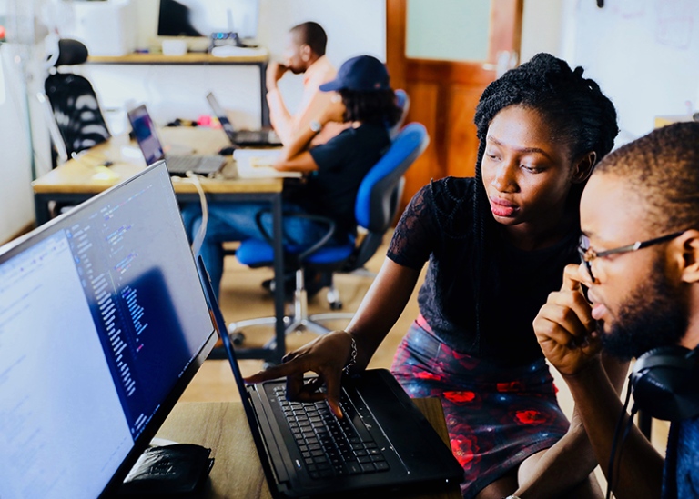 Man & woman work at computer (Unsplash.com)