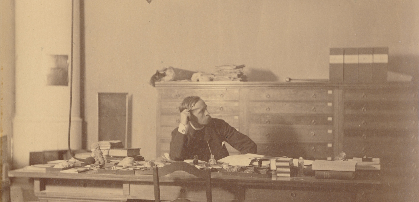 Norwegian geologist, Waldemar Christofer Brögger, sitting at his desk, 1881..