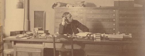 Norwegian geologist, Waldemar Christofer Brögger, sitting at his desk, 1881.