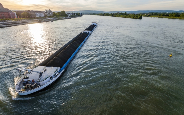 Cargo ship with coal bulk load on the river