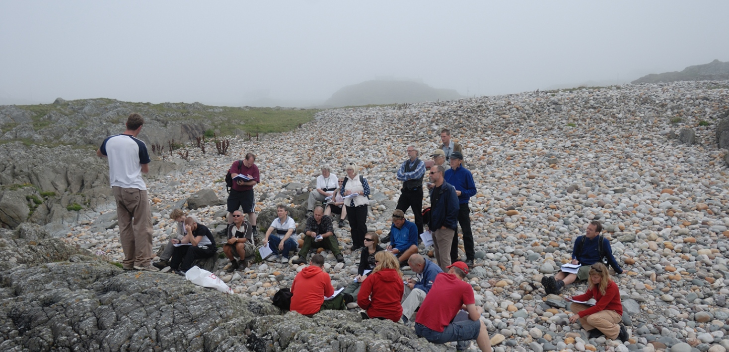 Teacher teaching students on field, on Islay, Scotland