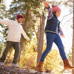 Two siblings playing in the forest