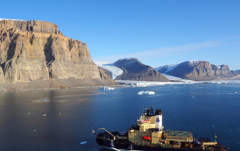 Icebreaker Oden outside northwestern Greenland, two glaciers on the background.