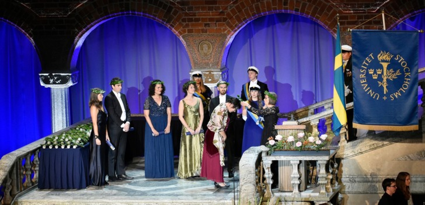 PhD's receiving their bearing wreath, on the stairwell scene.