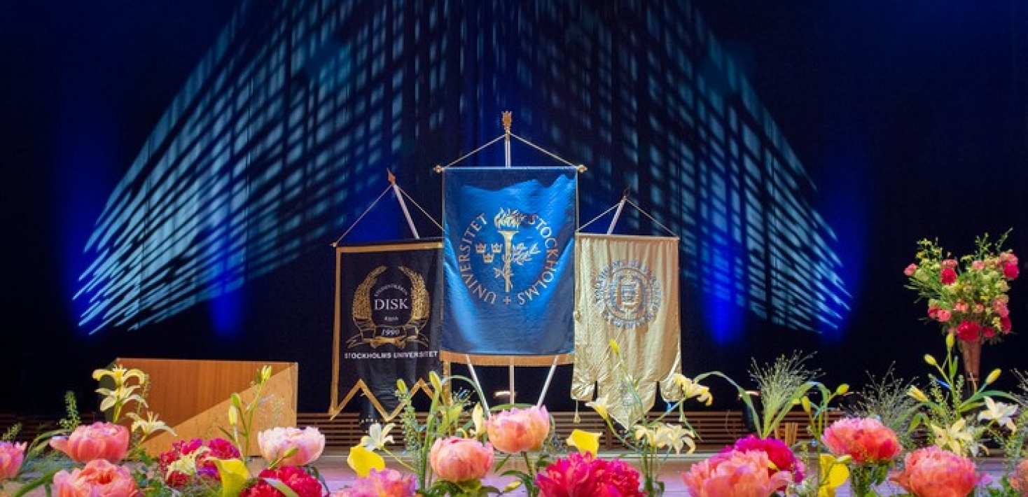 Stage with flowers and banners at Masters' Award Ceremony in Aula Magna. Photo: Ingmarie Andersson