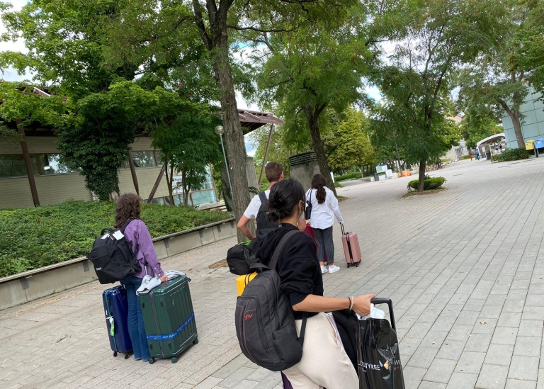 International students arriving at campus with their suitcases.