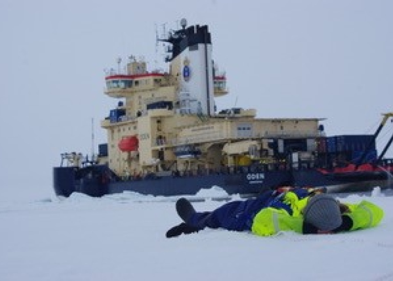 Ice breaker Oden and person resting on the ice. Photo: Sonja Murto