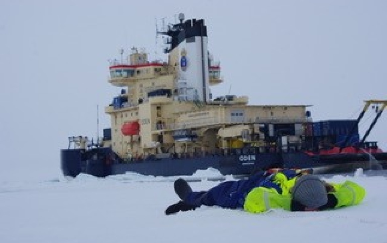 Ice breaker Oden and person resting on the ice. Photo:John Prytherch.