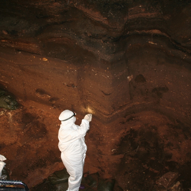 Researcher taking sampels from a inside a cave