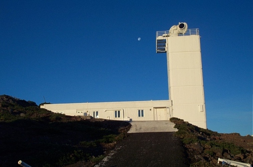 The Swedish Solar Telescope just opened in the morning sun, in front of blue skies.