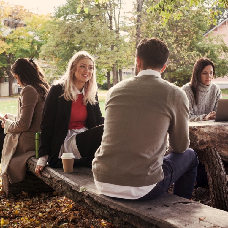 A group of students studying outdoors on campus.