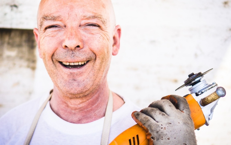 Happy blue collar worker. Photo: David Siglin on Unsplash.