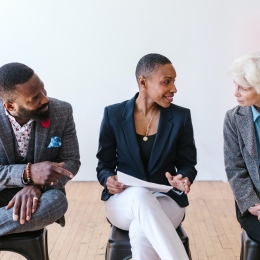 A man and a woman listening to an older lady at work. Photo: RODNAE Productions from Pexels.