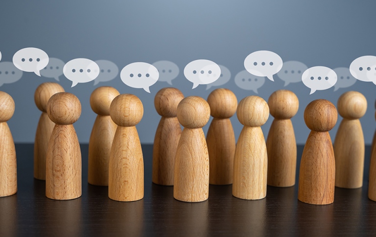 Wooden figures and speech bubbles.