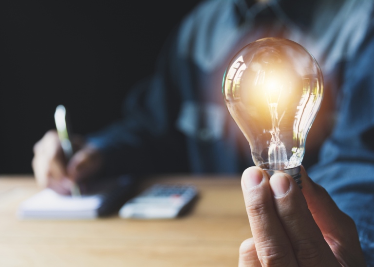 Male hand holding light bulb