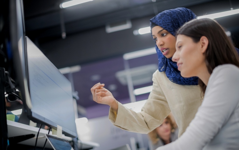 Multiethnics team working togheter with computer screen in front of them