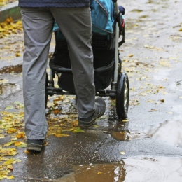 A father with a baby carriage. 