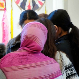 Mixed group of students in class room. 