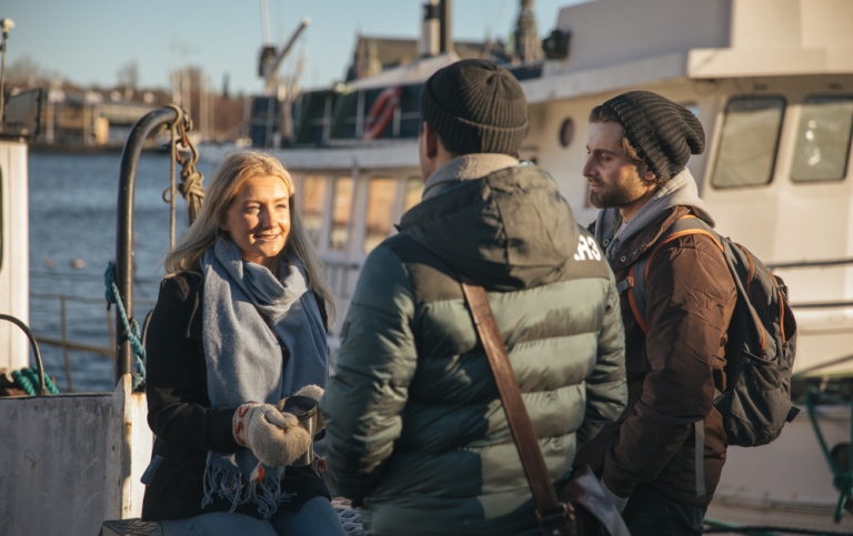 Two guys and a girl at Skeppsholmen in central Stockholm during winter.