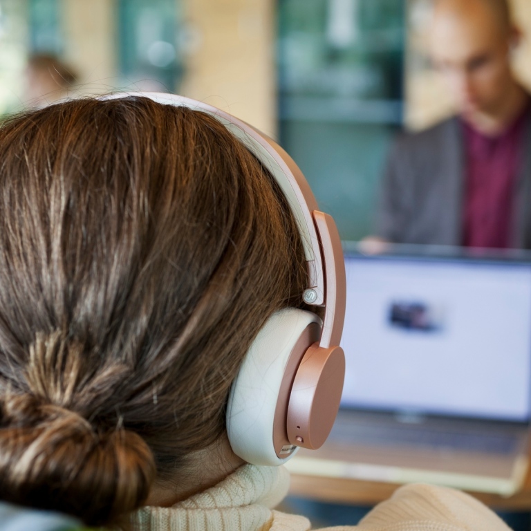 Female student with headphones at the computer Photo: Jens Olof Lasthein