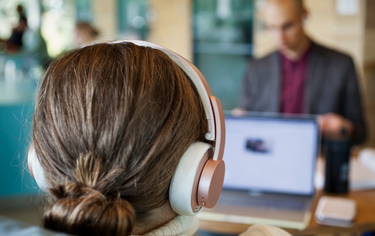 Female student with headphones at the computer Photo: Jens Olof Lasthein