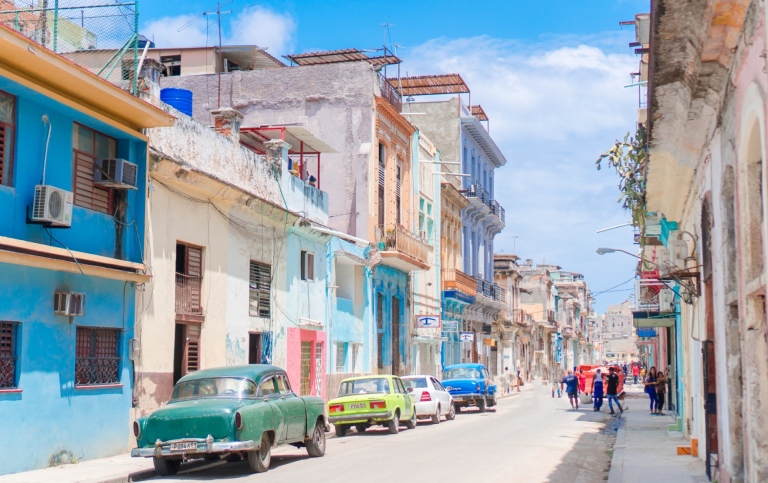 Authentic view of a street of Old Havana with old buildings and cars