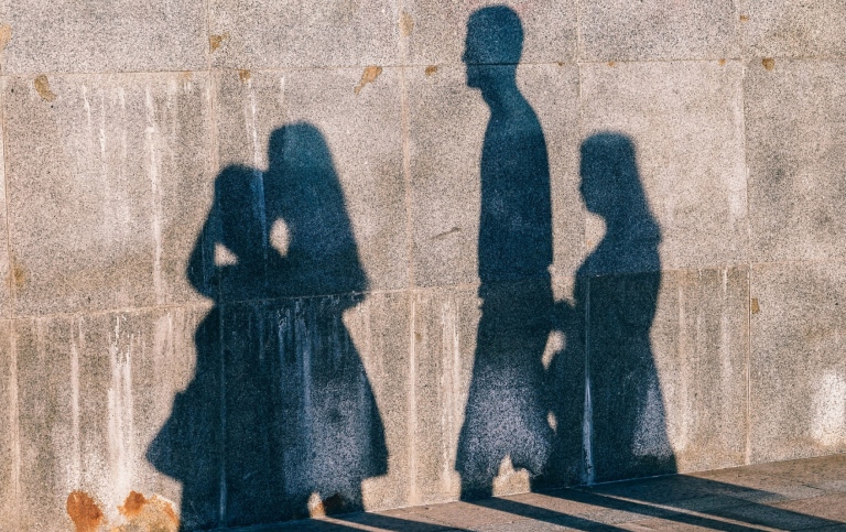 Shadows of people on a wall. 