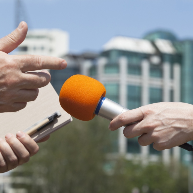 A microphone in front of a researcher who is interviewed