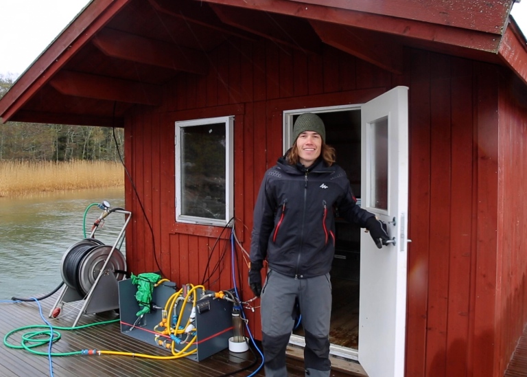 Florian Roth on a little houseboat where the equipment for measuring greenhouse gas emissions is installed.