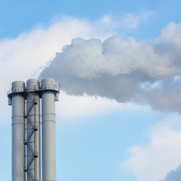 Emissions of smoke and steam from an industrial chimney.