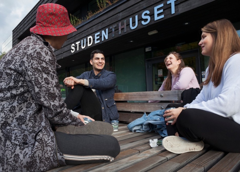 Four studens sitting outside talking