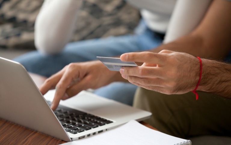 Genre photo: Two persons shopping online with credit card, illustrating research in 
