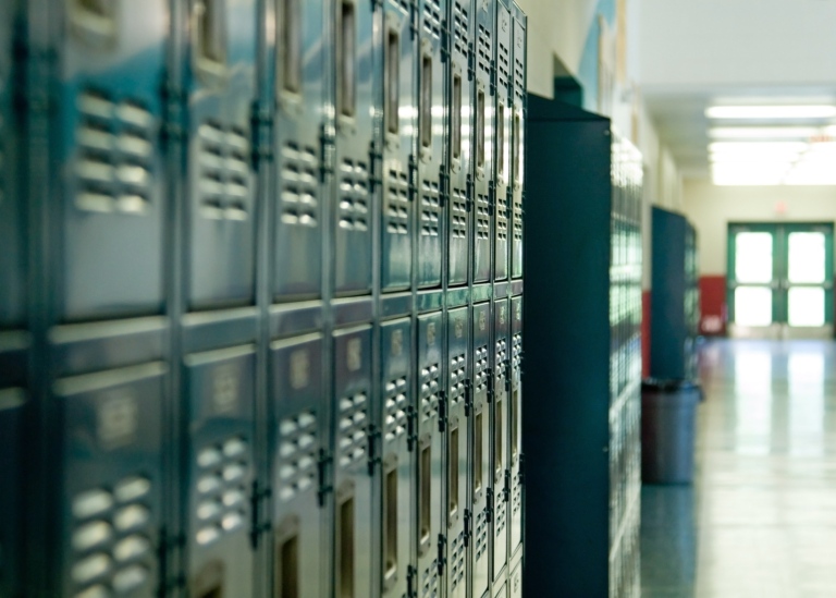 Genre photo: Rows of lockers in a school corridor. Illustrates research on tech enhanced learning