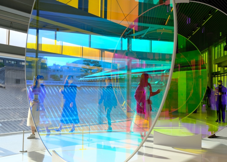 Photo: Luis Benito/Unsplash. Genre photo: People standing in artwork with transparent layers of color.Photo: Luis Benito/Unsplash