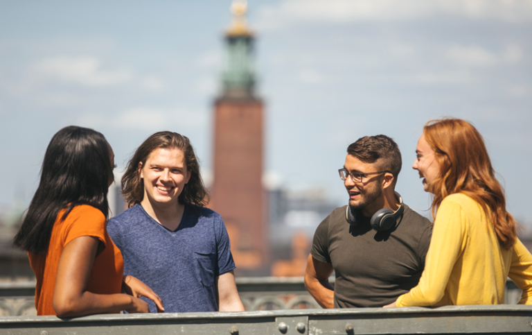 Samtal mellan studenter. I bakgrunden Stockholms Stadshus