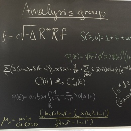 Blackboard with headline "Analysis group" and mathematical formulas.